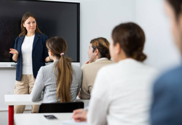 istock Competent female tutor teaching students in college classroom 1470691211