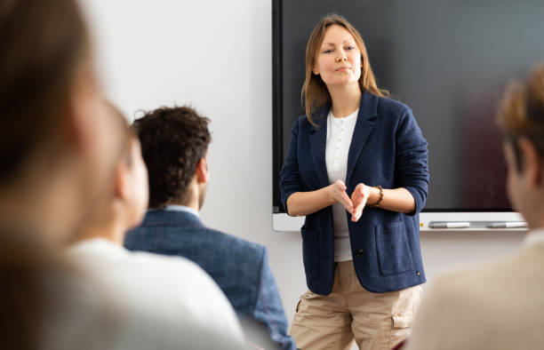 istock Knowledgeable female professor explaining subject to classroom full of students 1470691249