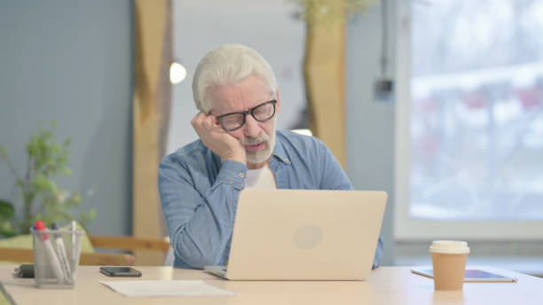 istock Old Man with Back Pain Working in Office 1470691326