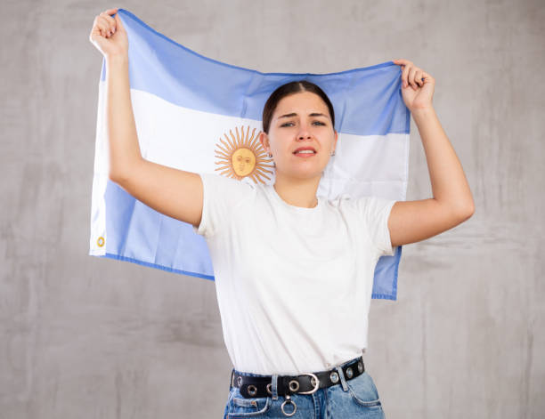 istock Sad young woman holding Argentina flag 1470691630