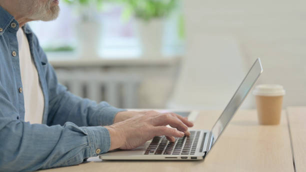 istock Side View of Male Hands Typing on Laptop 1470691866