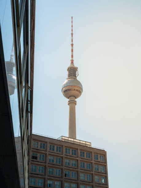 istock Famous Berlin Television Tower, observation Tower with office building in front, view from low angle during sunset, clear sky 1470691900