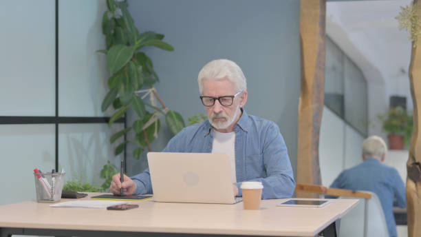 istock Male Graphic Designer Working on Laptop and Graphic Tablet 1470692741