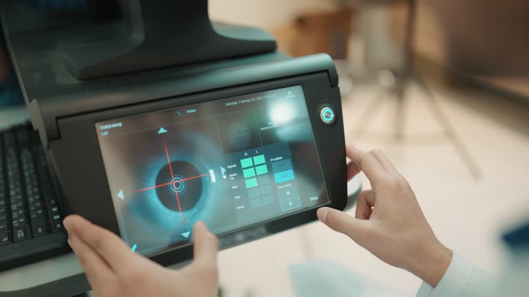 Ophthalmologist examines the patient's eye using equipment.