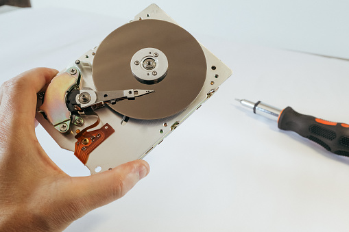 Repairing defect hard drive. Data hard drive backup disc hdd disk restoration restore recovery engineer work tool engineering maintenance repairman technology concept