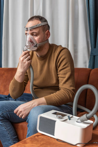istock Man sleeping with cpap mask because of obstructive sleep apnea 1470694701