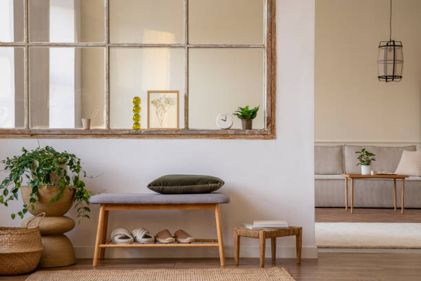 istock Minimalist composition of open space interior with mock up poster, bench, green pillow, plants, wooden coffee table, boho stool, window, modular sofa and personal accessories. Home decor. Template. 1470695222