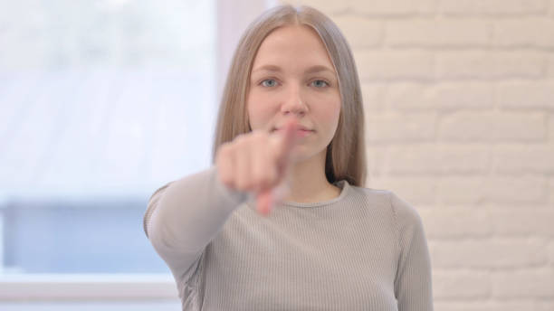 istock Young Woman Pointing at the Camera 1470696779