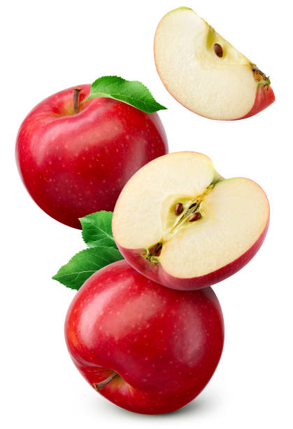 istock Red apple isolated. Whole, half and apple slice flying on white background. Red apples with leaves are falling. Full depth of field. 1470696874