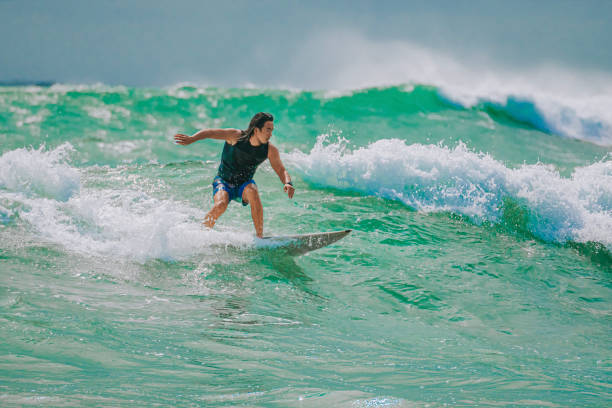 istock Asian Chinese Male Surfer riding wave in Pacific Ocean 1470696921