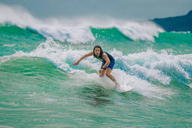 istock Asian Chinese Male Surfer riding wave in Pacific Ocean 1470696937