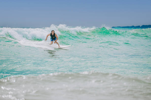 istock Asian Chinese Male Surfer riding wave in Pacific Ocean 1470696954