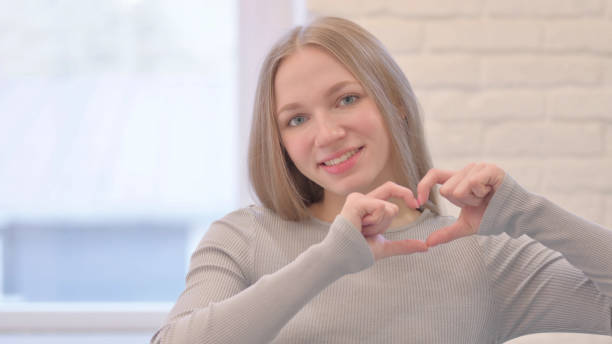 istock Loving Young Woman showing Heart Shape 1470696957