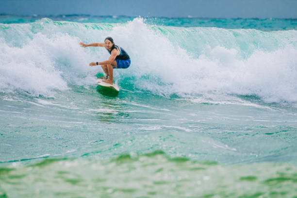 istock Asian Chinese Male Surfer riding wave in Pacific Ocean 1470696988