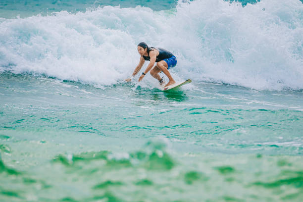 istock Asian Chinese Male Surfer riding wave in Pacific Ocean 1470696989