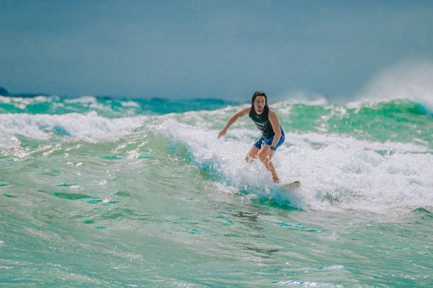 istock Asian Chinese Male Surfer riding wave in Pacific Ocean 1470697068
