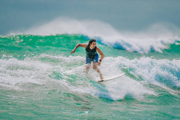 istock Asian Chinese Male Surfer riding wave in Pacific Ocean 1470697103