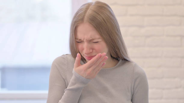 istock Sick Young Woman suffering with Cough 1470697111