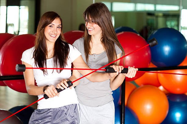 Two happy young women in the gym stock photo