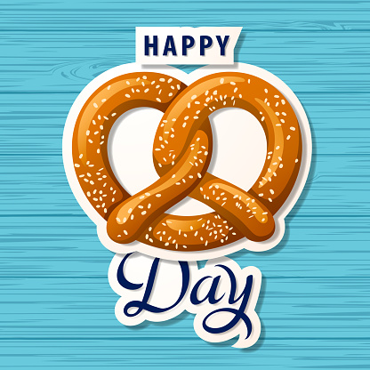 Celebrate National Pretzel Day with salty pretzel on the blue wood pattern