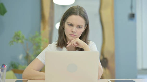 istock Pensive Casual Young Woman Thinking at Work 1470698170