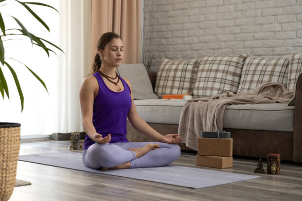 istock Young woman practicing yoga at home 1470698268