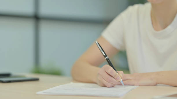 istock Close Up of Young Woman Writing at Work 1470698717