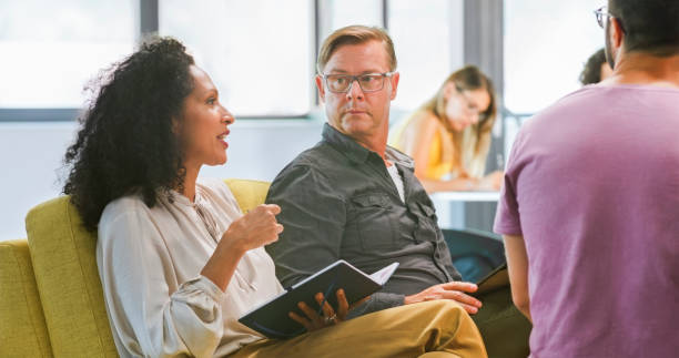 istock Businesswoman talking with colleagues 1470698819