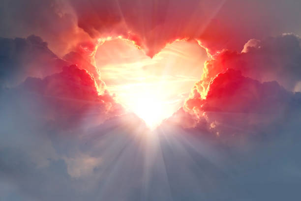 Red heart shaped clouds at sunset. Beautiful love background with copy space.Valentine's Day concept.