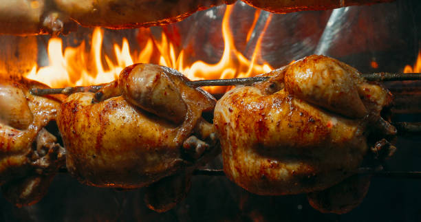 Delicious Golden Brown Rotisserie Chickens Turn On Spit. Tasty G stock photo