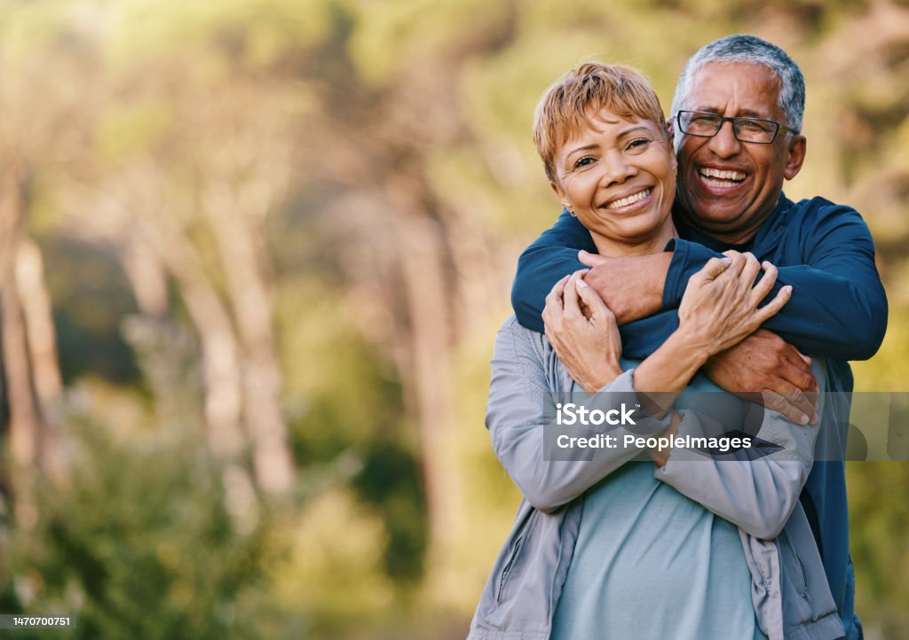 Nature, love and portrait of a senior couple hugging in a garden while on romantic outdoor date. Happy, smile and elderly people in retirement embracing in park while on a walk for fresh air together Senior Couple Stock Photo