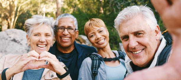 Nature, selfie and senior friends hiking together in a forest while on an outdoor adventure. Happy, smile and portrait of a group of elderly people trekking in woods for wellness, health and exercise Nature, selfie and senior friends hiking together in a forest while on an outdoor adventure. Happy, smile and portrait of a group of elderly people trekking in woods for wellness, health and exercise happiness four people cheerful senior adult stock pictures, royalty-free photos & images