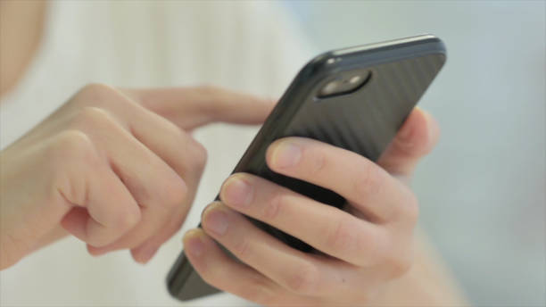 istock Close up of Female Hand Using Smartphone 1470702060