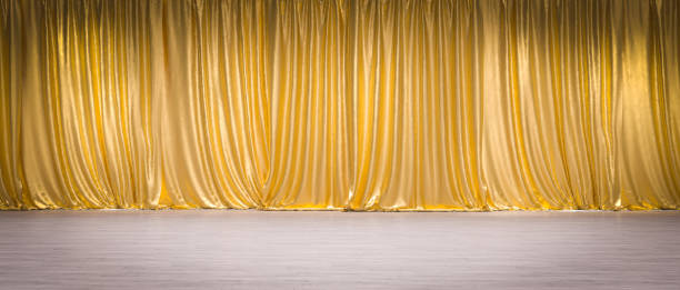 istock gold curtains on light wooden floor. 1470703233