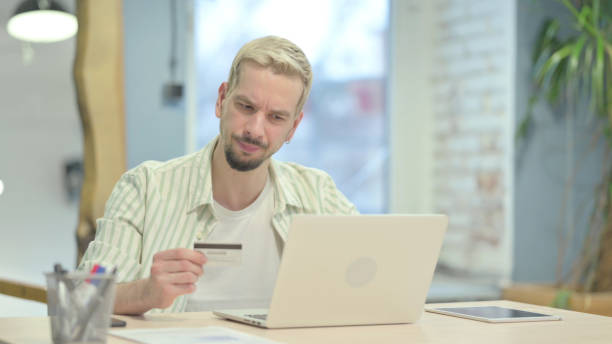 istock Young Man Upset by Online Payment Rejection on Laptop 1470703482