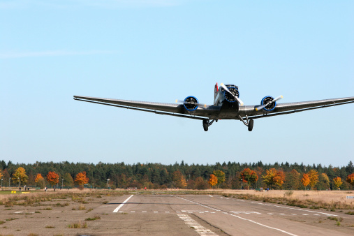 Photo of an airplane before taking off, pictured on the ground at the airport runway.