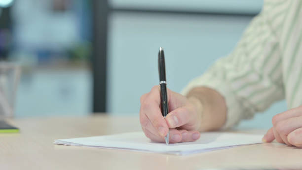 istock Close up of Young Man Writing in Office 1470704159