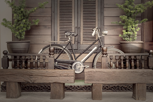 vintage black bicycle in front of the balcony house,filter effect