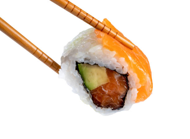 istock Sushi roll in chopsticks isolated from the white background 1470705816