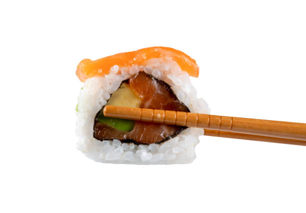 istock Sushi roll in chopsticks isolated from the white background 1470706585