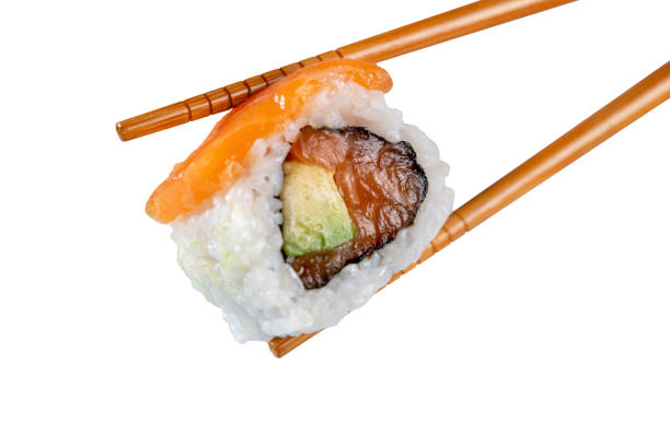 istock Sushi roll in chopsticks isolated from the white background 1470706587