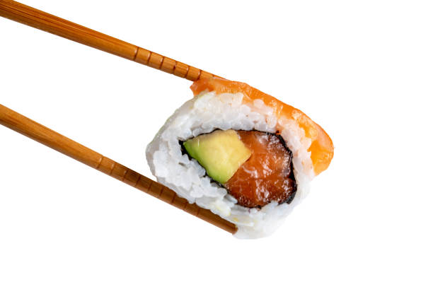 istock Sushi roll in chopsticks isolated from the white background 1470706674