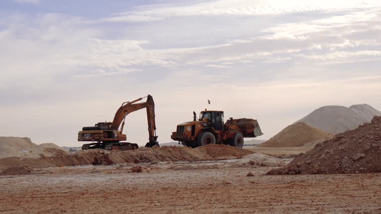 Excavators And A Grader In The Process Of Digging