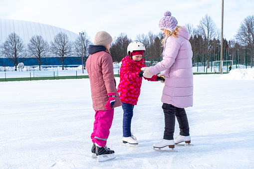 Family skating in the school yard, Finland Lahti.