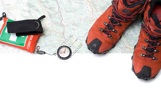 istock Hiking shoes and compass on map 147070734