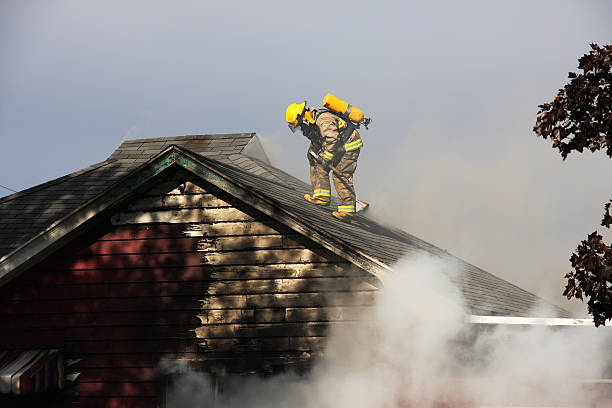 istock Fireman on top of a burning house 147070800