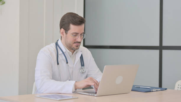 istock Doctor Typing on Laptop in Clinic 1470708129