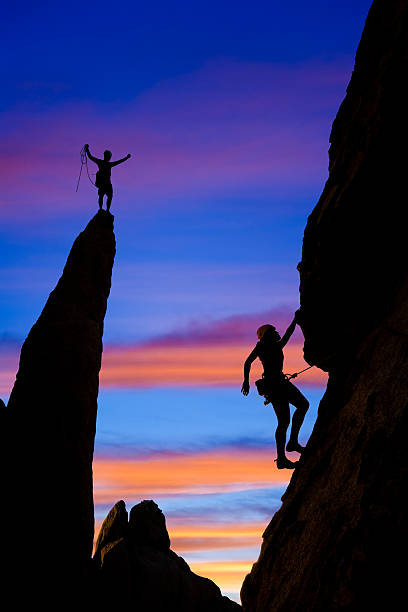 istock Team of rock climbers reaching the summit. 147070974