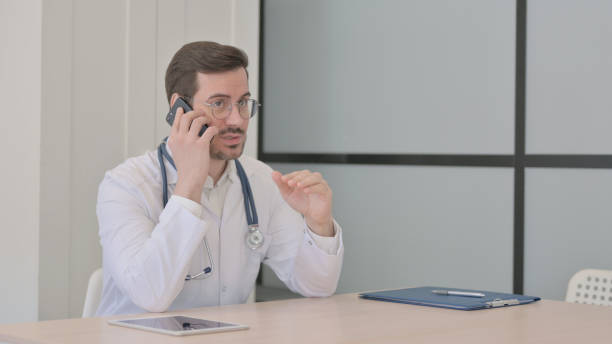 istock Doctor Talking on Phone in Clinic 1470710968
