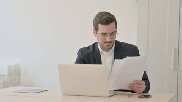 istock Businessman Working on Laptop and Documents 1470711233
